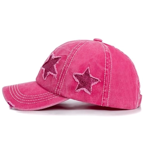 Detail of rose pink washed cotton baseball cap with sequined star patch and frayed edges