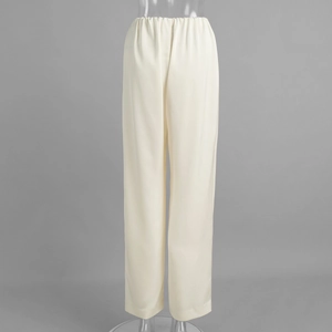 Detail of cream satin straight-leg trousers showing elastic waistband and smooth fabric
