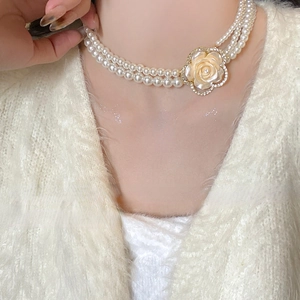 Elegant double-layered pearl necklace with a diamond-encrusted camellia flower pendant