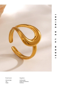 Detail view of gold wave teardrop ring featuring minimalist organic lines on textured surface