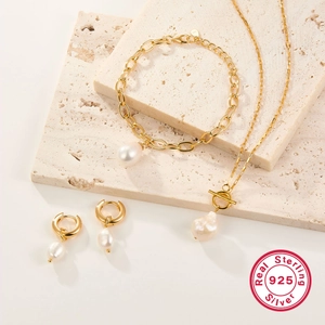 Detail of 925 sterling silver jewelry set featuring freshwater pearls on a stone base