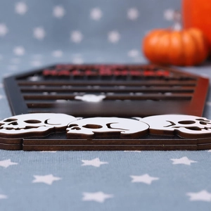 Detail of wooden Halloween coffin decor with skulls and Happy Halloween text