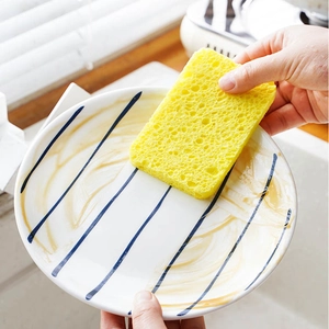 Kitchen cellulose sponge cleaning yellow wood pulp cotton on ceramic plate
