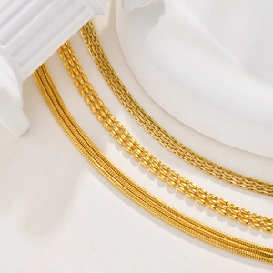 Golden multi-layer stainless steel hammer round chain bracelet on a white column
