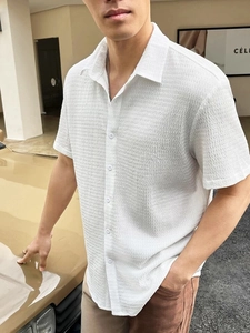 Detail of white short sleeve shirt with waffle texture fabric and classic button-up collar