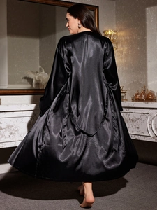 Rear view of long black satin bathrobe showing smooth silky texture and glossy finish