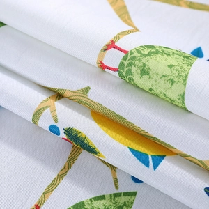 Close-up of linen fabric showing lemon print texture and weave on microwave cover