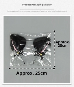 Detail of cute black cat ear headband with pink inner ears and bells in clear packaging