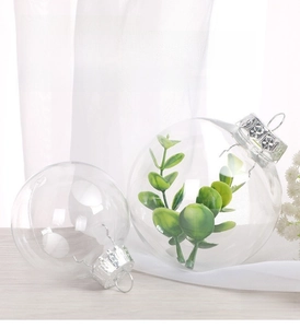 Close-up of clear PET Christmas ball with silver metal cap and internal greenery decoration