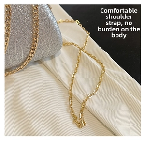 Detail of silver glitter evening bag featuring a premium gold metal chain strap connector