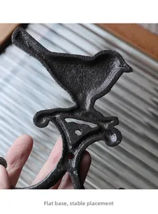 Detailed macro view showing the flat and stable base of the vintage cast iron bird hook