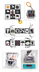 Macro view of newborn black and white sensory cloth book with size and weight specs