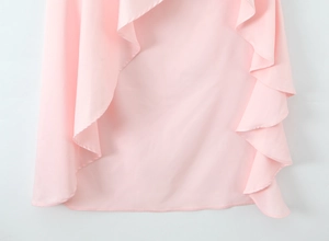 Detail of pink dress featuring layered ruffles and delicate chiffon fabric texture