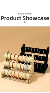 Detailed view of 3-tier jewelry stand in linen and velvet displaying beaded bracelets