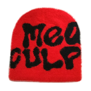 Detail of red fuzzy knit beanie featuring a black textured MEO GULP letter design