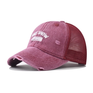 Detail of burgundy distressed mesh trucker hat with SHIT SHOW SUPERVISOR print