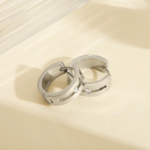 Polished silver titanium steel hoop earrings featuring a single round zircon inlay