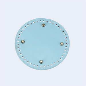 Light blue circular PU leather bag base with pre-punched holes and four gold metal feet