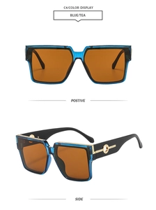 Detail view of square blue sunglasses with gold metal logo on the temple and tea lenses