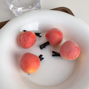 Detailed close-up of cute peach hair clips with realistic fuzzy texture and metal clips