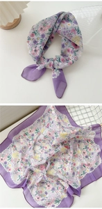 Detailed view of a purple floral cotton linen scarf showing both knot style and fabric patterns