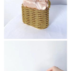 Detail of a luxury gold beaded evening bucket bag with silk drawstring and metal frame