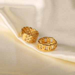 Detail of 18k gold plated stainless steel braided mesh and chain rings on white silk