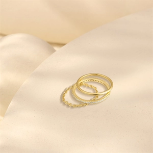 Detail view of S925 sterling silver three-piece ring set with gold finish and diamonds