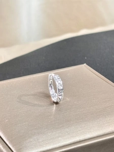 Detail view of S925 silver hoop earring with square-cut cubic zirconia in a geometric setting