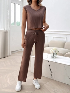 Detail of brown ribbed knit two-piece set featuring drawstring high waist pants and crop top