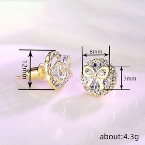 Elegant gold bow stud earrings with cubic zirconia stones showing front and side view