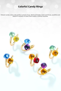 Macro detail of colorful square gemstone bypass rings in polished gold plated setting