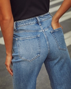 Detail of high waist fit and rear pockets on retro blue denim stretch jeans