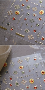 Macro detail of M-773 gold foil nail stickers with colorful crystal faux gems and moon motifs
