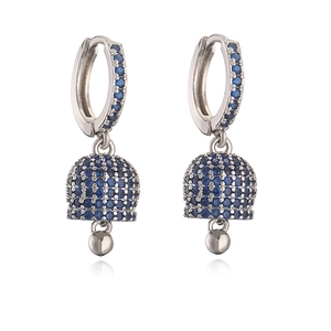 Detailed view of silver bell earrings with vibrant blue pavé zircon setting