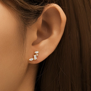 Detailed close-up of S925 silver gold earrings with marquise and rectangular cubic zirconia