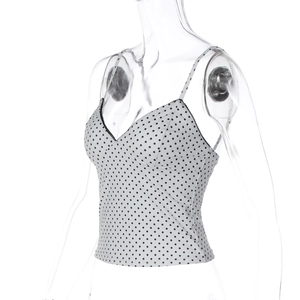 Detail showing white camisole with black polka dots, V-neckline, and slim fit design