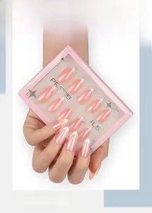 Detail of pink French almond press-on nails with white tips in high-gloss finish