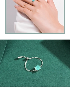 Detail of adjustable silver chain ring featuring a square turquoise gemstone and ball clasp