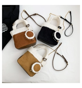 Detailed view of three shearling bucket bags with mini coin purses and chain straps