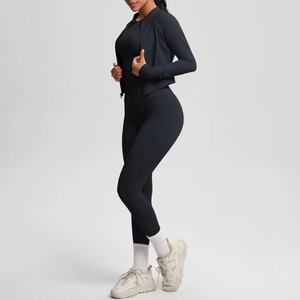 Close-up of black slimming sports jacket and high-waist yoga pants on model in studio