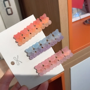 Close-up of three colorful gradient matte gummy bear hair clips on a card