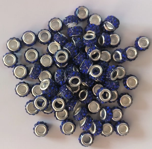Close-up of blue crystal rhinestones set in metallic large hole beads for DIY jewelry making