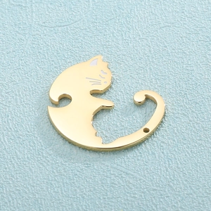 Macro view of a polished golden cat-shaped metal pendant for jewelry making
