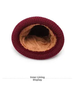 Detail view of winter knitted hat showing thick brown fleece lining and burgundy exterior