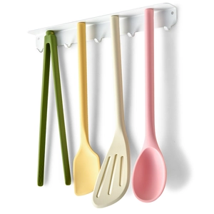 Magnetic silicone kitchen utensil set with spatula and tongs on a white hanging rack