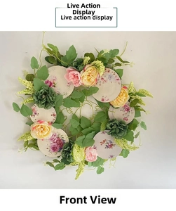 Front view detail of a spring floral wreath with pink blossoms and porcelain patterns