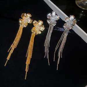 Elegant 18k gold and silver floral pearl drop earrings with long metal tassels