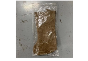 Detailed view of a brown fabric Christmas stocking wrapped in clear plastic packaging
