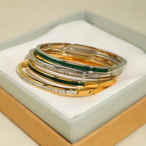 Colorful gemstone gold and silver plated stainless steel bangles set in a jewelry box